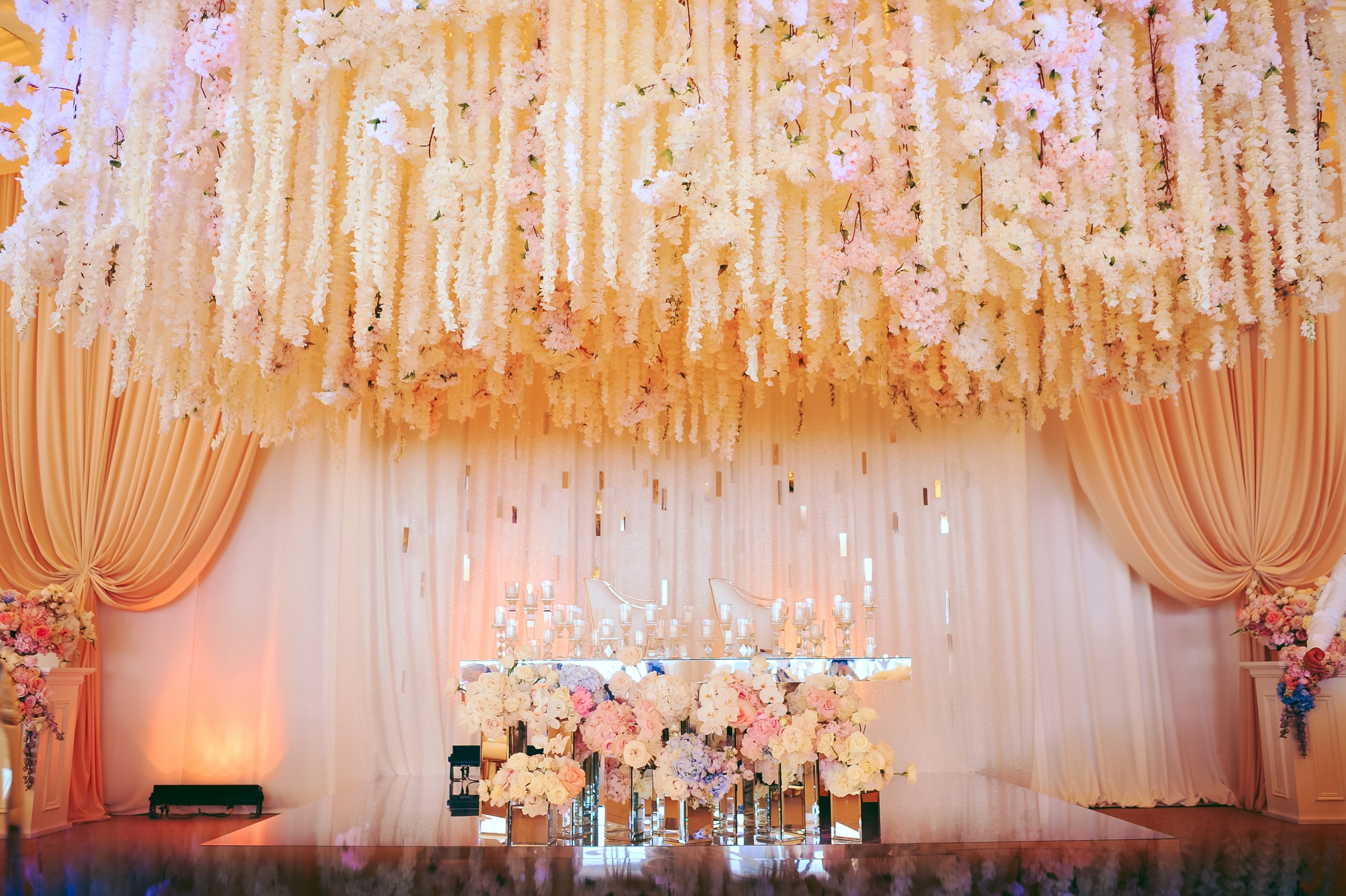 groom and bride's wedding table decorated with flowers and candl